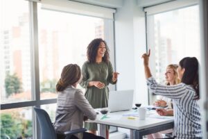 A group of professional woman collaborating and networking in a conference room.
