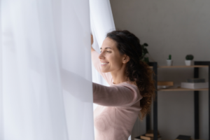 A woman who is practicing wealth management habits taking a moment to reflect on her financial goals and decisions